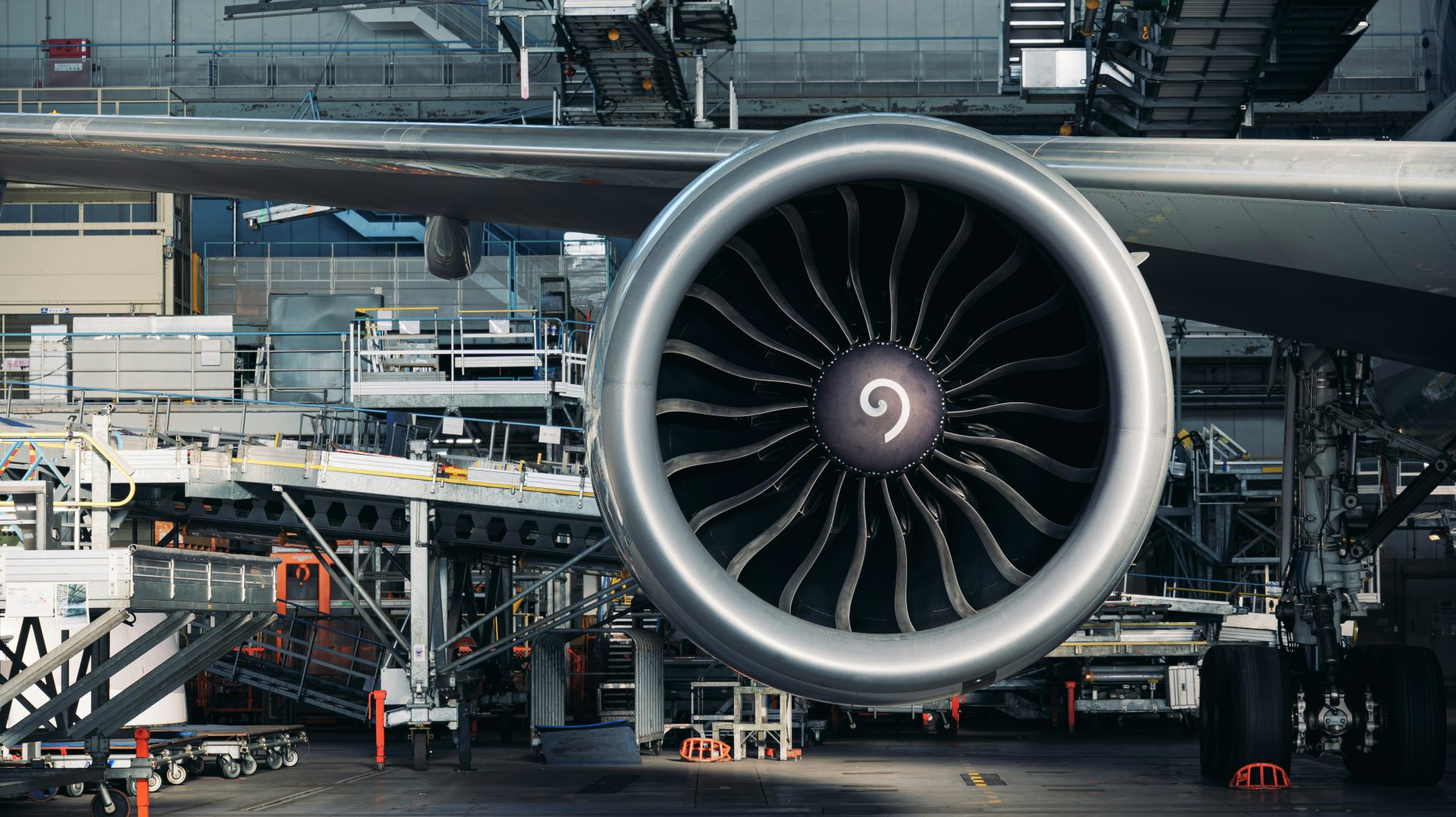 A large jet engine sitting on top of an airport tarmac